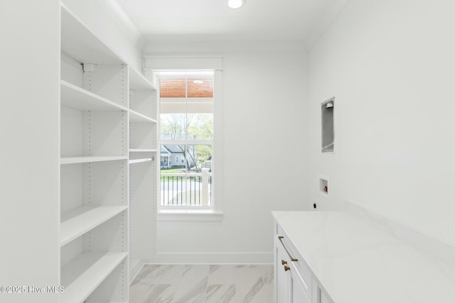 3404 Eagle Crest Dr SW, Supply, NC 28462 - washroom featuring hookup for a washing machine, light marble finish flooring, cabinet space, and baseboards