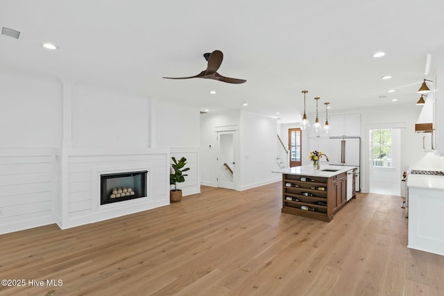 3404 Eagle Crest Dr SW, Supply, NC 28462 - living room featuring light wood-style floors, recessed lighting, stairs, a ceiling fan, and a fireplace