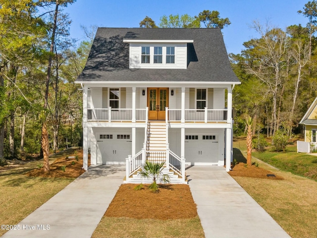 3404 Eagle Crest Dr SW, Supply, NC 28462 - coastal inspired home with stairs, a porch, driveway, and a garage