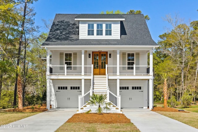 3404 Eagle Crest Dr SW, Supply, NC 28462 - coastal home with stairway, french doors, covered porch, concrete driveway, and a garage