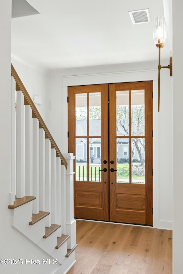 3404 Eagle Crest Dr SW, Supply, NC 28462 - entrance foyer with stairs, light wood-style flooring, and french doors