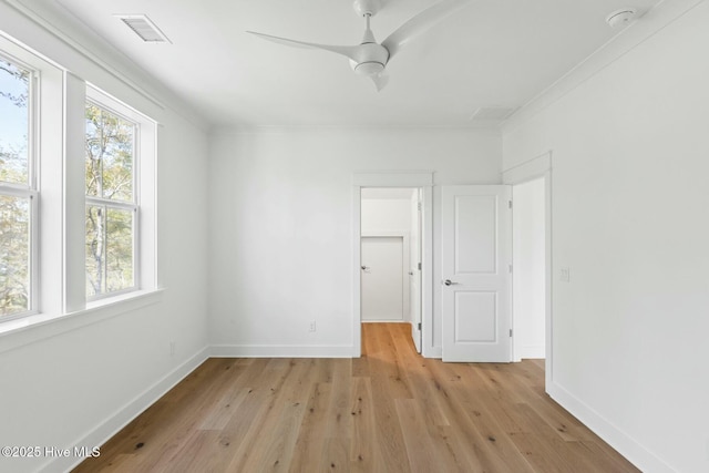 3404 Eagle Crest Dr SW, Supply, NC 28462 - unfurnished bedroom featuring light wood-style floors, baseboards, a walk in closet, a ceiling fan, and crown molding