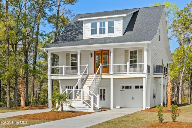 3404 Eagle Crest Dr SW, Supply, NC 28462 - beach home with a porch, stairway, concrete driveway, a garage, and roof with shingles