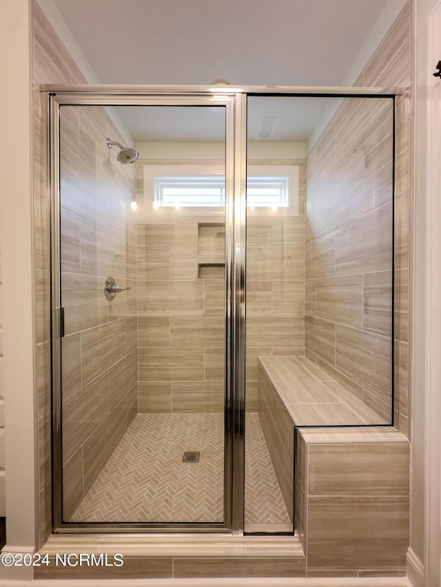 bathroom with a shower with shower door