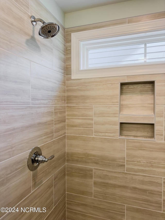 interior details with a tile shower