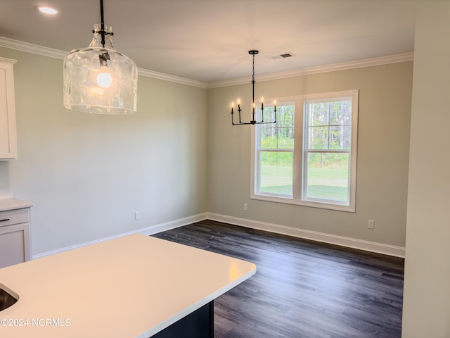 kitchen featuring dark wood-type flooring, hanging light fixtures, ornamental molding, white cabinetry, and a chandelier