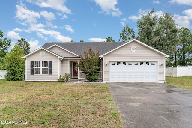 ranch-style house featuring a garage and a front lawn