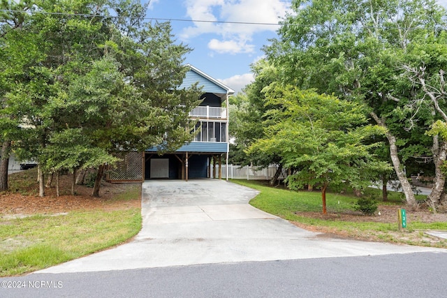 view of front of home featuring a balcony and a carport