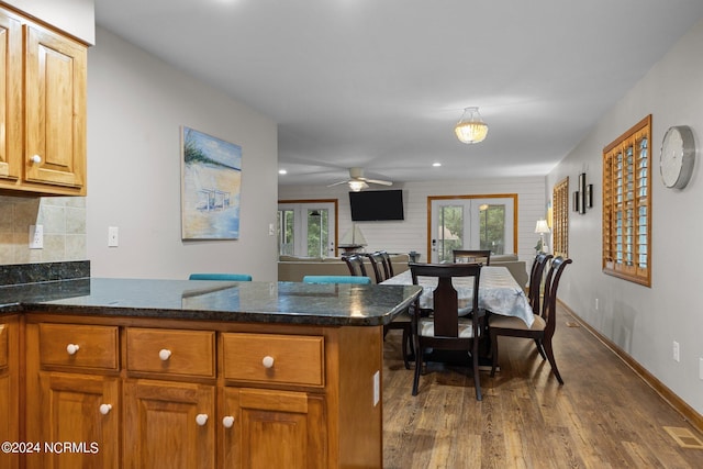 kitchen with ceiling fan, french doors, dark wood-type flooring, tasteful backsplash, and kitchen peninsula