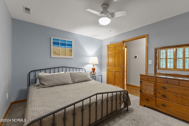 bedroom with light carpet and ceiling fan