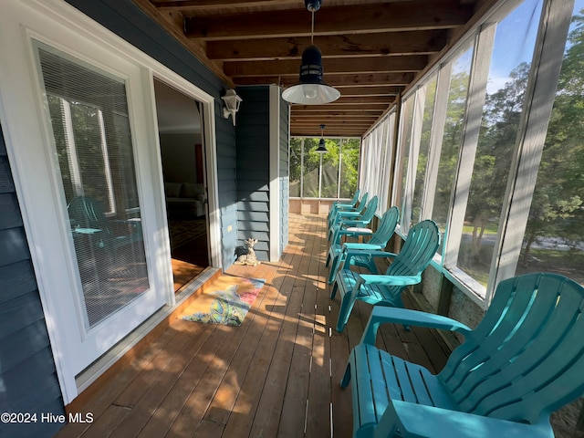 unfurnished sunroom with beamed ceiling