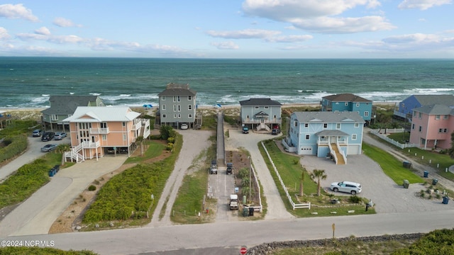 bird's eye view featuring a water view and a beach view