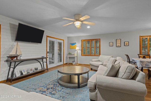 living room featuring ceiling fan and hardwood / wood-style floors