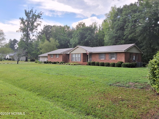 single story home featuring a front lawn and central AC unit