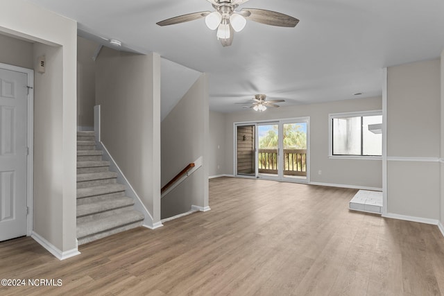 unfurnished living room featuring light hardwood / wood-style flooring and ceiling fan