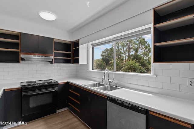 kitchen with light wood-type flooring, stainless steel dishwasher, sink, black electric range oven, and backsplash