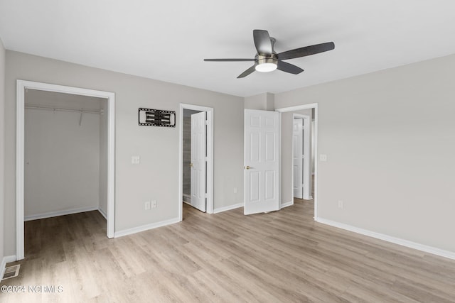 unfurnished bedroom featuring ceiling fan, light wood-type flooring, and a closet