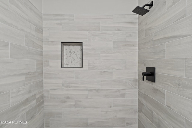 bathroom with a tile shower