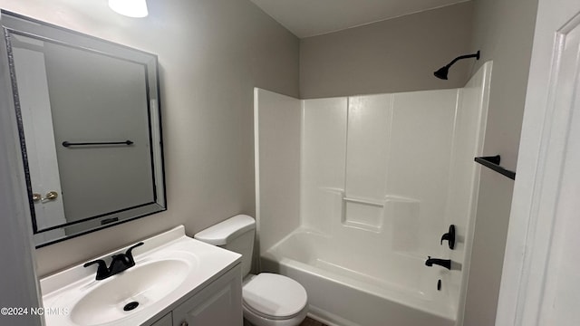 full bathroom featuring tub / shower combination, vanity, and toilet