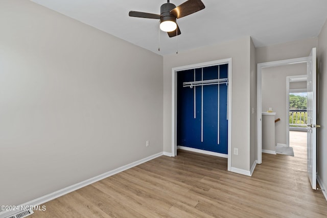 unfurnished bedroom featuring a closet, light hardwood / wood-style flooring, and ceiling fan