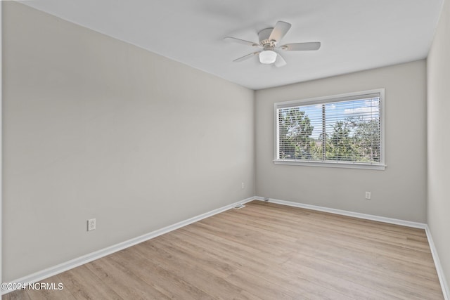 empty room with ceiling fan and light hardwood / wood-style floors