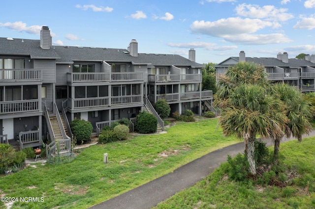 view of home's community with a lawn