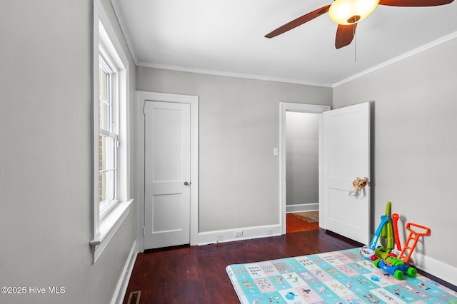 unfurnished bedroom with dark wood-type flooring, ceiling fan, and crown molding