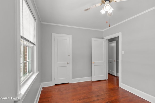 unfurnished bedroom with ornamental molding, dark hardwood / wood-style floors, and ceiling fan