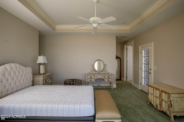 carpeted bedroom with ceiling fan, crown molding, and a tray ceiling