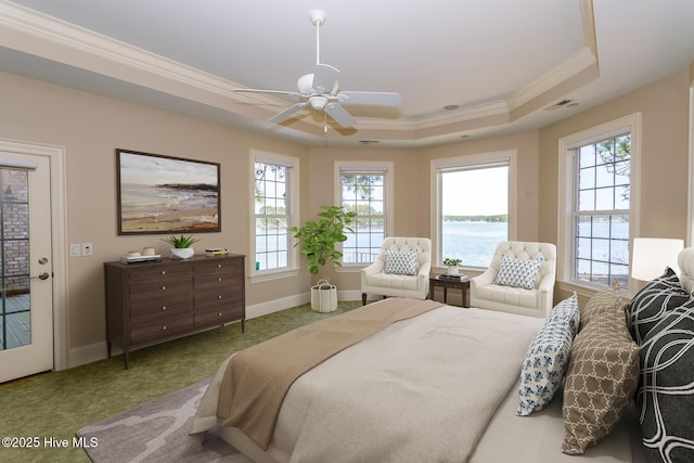 carpeted bedroom with baseboards, ornamental molding, visible vents, a raised ceiling, and a water view