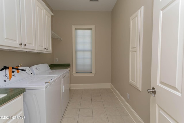 washroom with light tile patterned floors, cabinet space, visible vents, separate washer and dryer, and baseboards