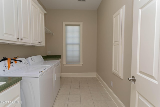 laundry room featuring visible vents, baseboards, independent washer and dryer, cabinet space, and light tile patterned flooring
