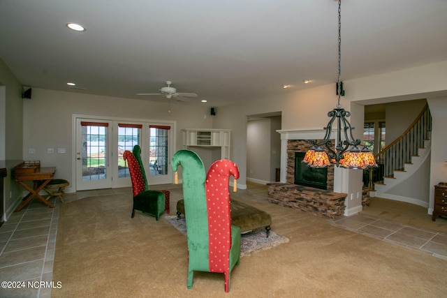 carpeted dining room featuring a fireplace and ceiling fan