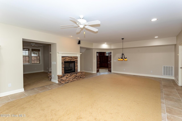 unfurnished living room featuring a stone fireplace, recessed lighting, tile patterned flooring, visible vents, and ceiling fan