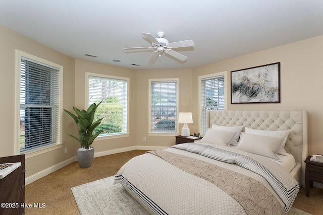 bedroom featuring carpet flooring, baseboards, multiple windows, and visible vents