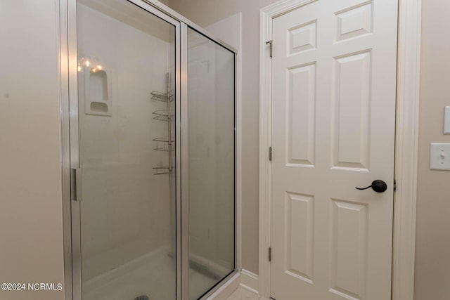 full bath with a shower stall