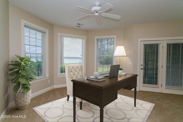 carpeted home office with visible vents, baseboards, and a ceiling fan