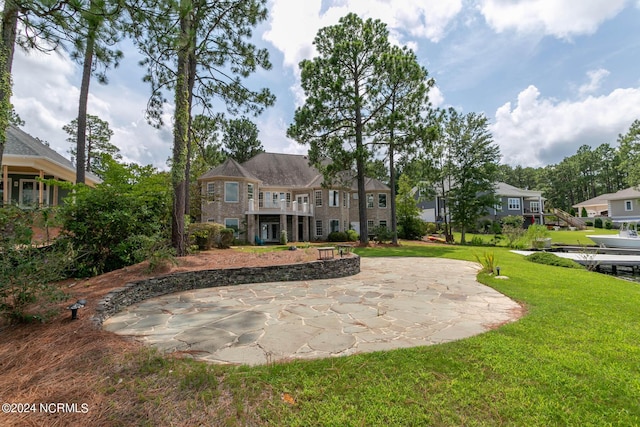 back of house featuring a patio and a lawn