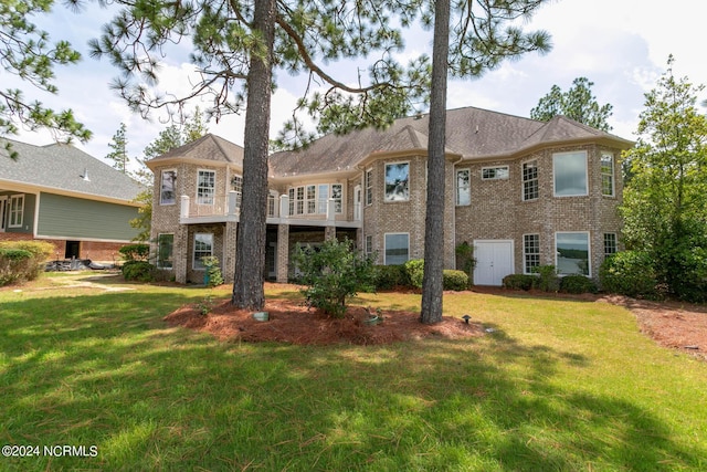 back of house with brick siding and a lawn