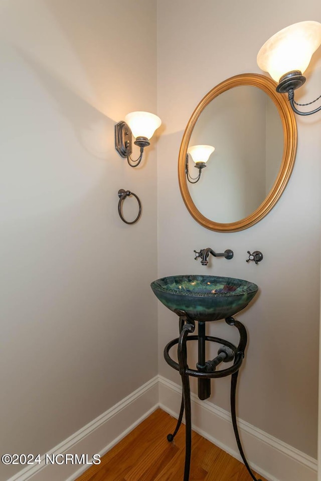 bathroom featuring wood finished floors and baseboards