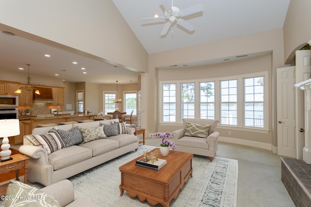 living area with light carpet, recessed lighting, visible vents, ceiling fan, and high vaulted ceiling