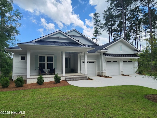 3772 Barnesmore Dr, Castle Hayne, NC 28429 - view of front of property with a standing seam roof, a porch, a garage, a front lawn, and driveway