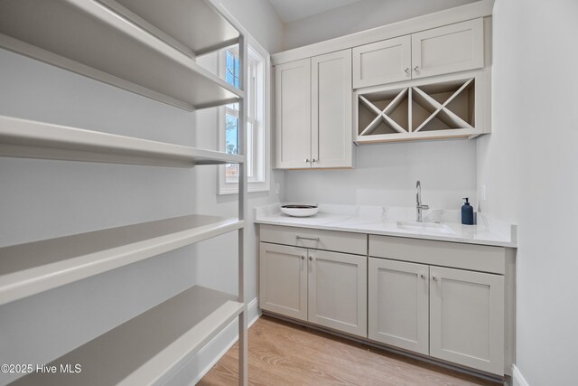 3772 Barnesmore Dr, Castle Hayne, NC 28429 - bar with a sink and light wood-style floors