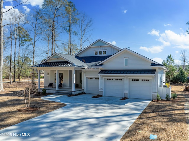 3772 Barnesmore Dr, Castle Hayne, NC 28429 - modern farmhouse featuring a standing seam roof, covered porch, concrete driveway, and a metal roof