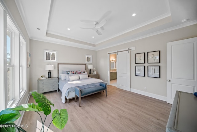 3772 Barnesmore Dr, Castle Hayne, NC 28429 - bedroom with a barn door, a tray ceiling, light wood-type flooring, ornamental molding, and recessed lighting