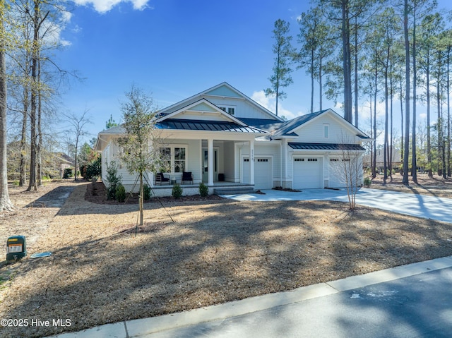 3772 Barnesmore Dr, Castle Hayne, NC 28429 - view of front of home with covered porch, a standing seam roof, driveway, a metal roof, and an attached garage