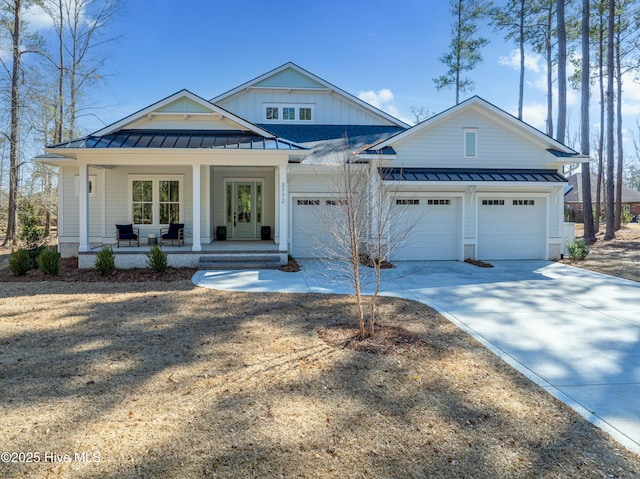 3772 Barnesmore Dr, Castle Hayne, NC 28429 - modern farmhouse style home with a standing seam roof, a metal roof, a porch, driveway, and an attached garage