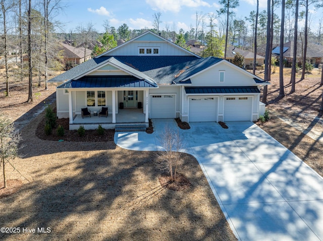 3772 Barnesmore Dr, Castle Hayne, NC 28429 - view of front of house featuring a standing seam roof, covered porch, a shingled roof, driveway, and an attached garage