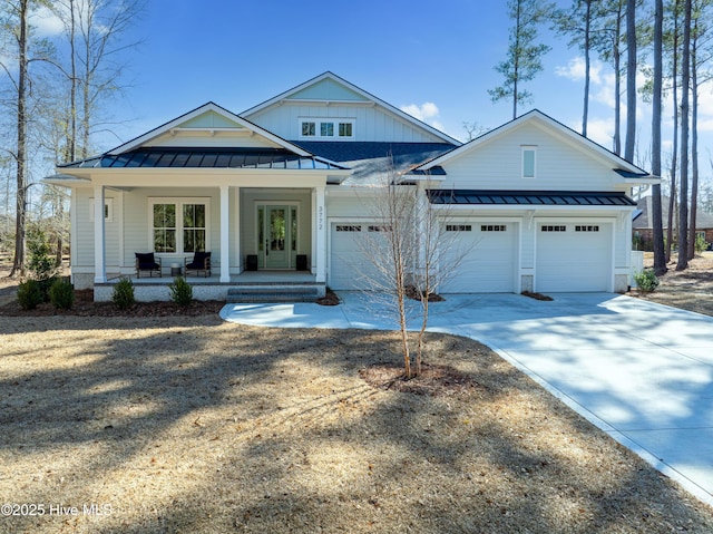3772 Barnesmore Dr, Castle Hayne, NC 28429 - modern inspired farmhouse with a standing seam roof, covered porch, concrete driveway, an attached garage, and a metal roof