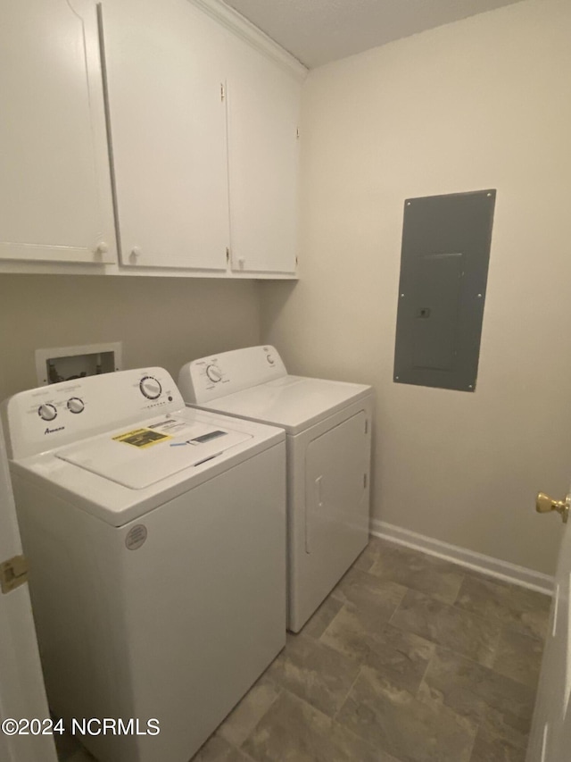 washroom featuring cabinets, electric panel, and independent washer and dryer